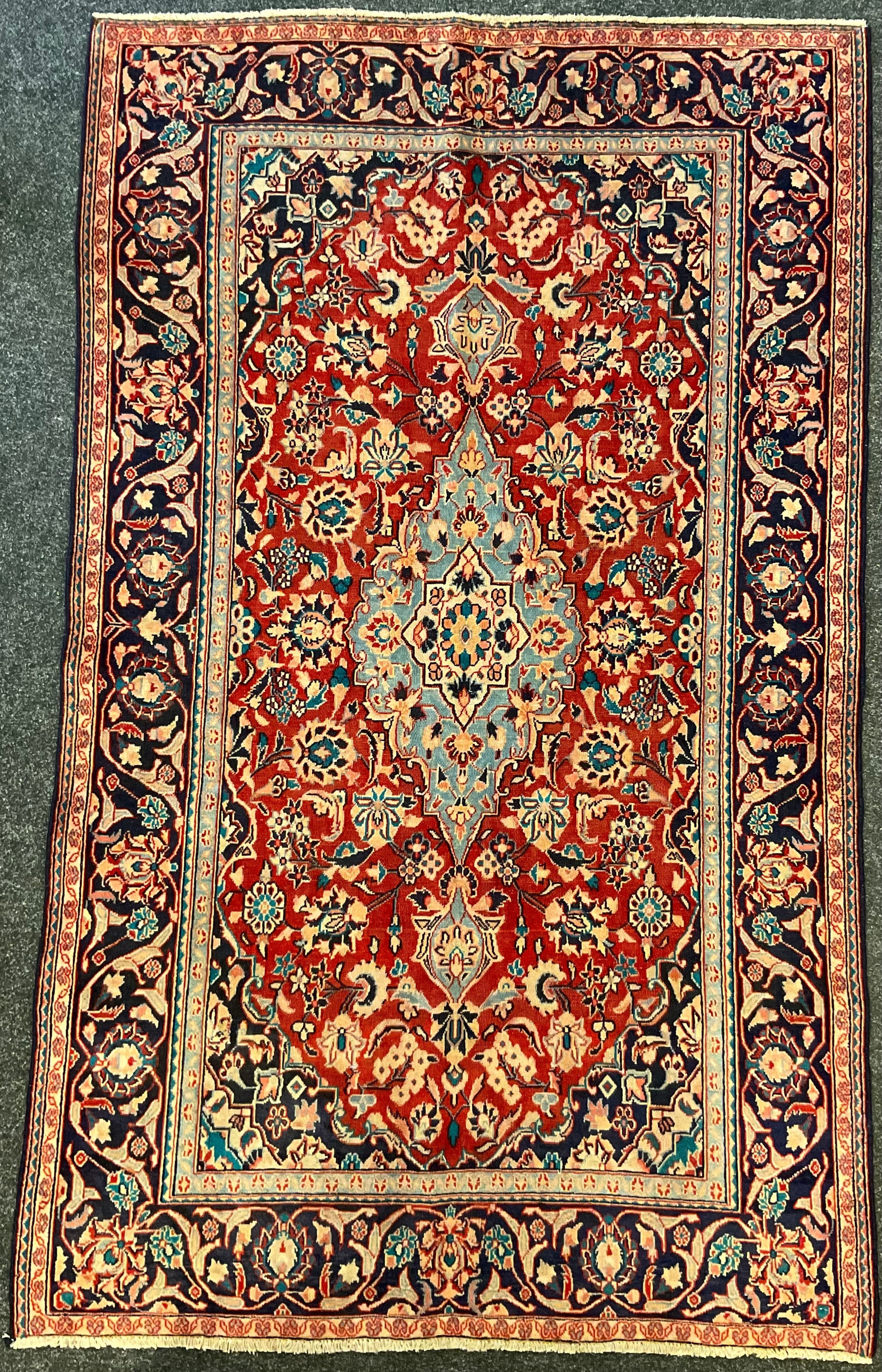A Najafabad / Najaf-Abad rug / carpet, the central medallion knotted in pale blue, within an