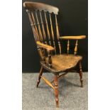 An early 20th century Farmhouse spindle-back elbow chair, shaped seat, H stretcher, 112cm tall.