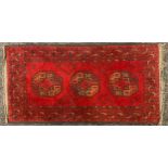 An Afghan type wool rug / prayer mat, 98cm x 51cm.