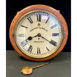 A Prescot Clock Co wall clock/time piece, cream dial, bold Roman numerals, broad Arrow/Crows Foot