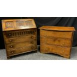 A mid 20th century oak bureau, three-panel fall door to top with carved linen-fold decoration, above