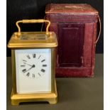 A travelling carriage clock, brass case, white dial, leather travel case, 14.5cm high, 10.5cm, 9.5cm