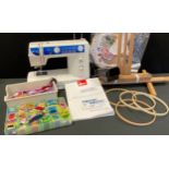 An Elna Explore 220-240 multi stitch sewing machine, instructions, threads, needlework patterns,