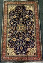 A central Persian Sarouk rug / carpet, hand-knotted with a central medallion in an intricate field