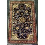 A central Persian Sarouk rug / carpet, hand-knotted with a central medallion in an intricate field