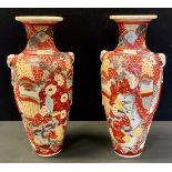A pair of Japanese Satsuma pottery vases, decorated with traditional figures and motifs, 45,5cm high