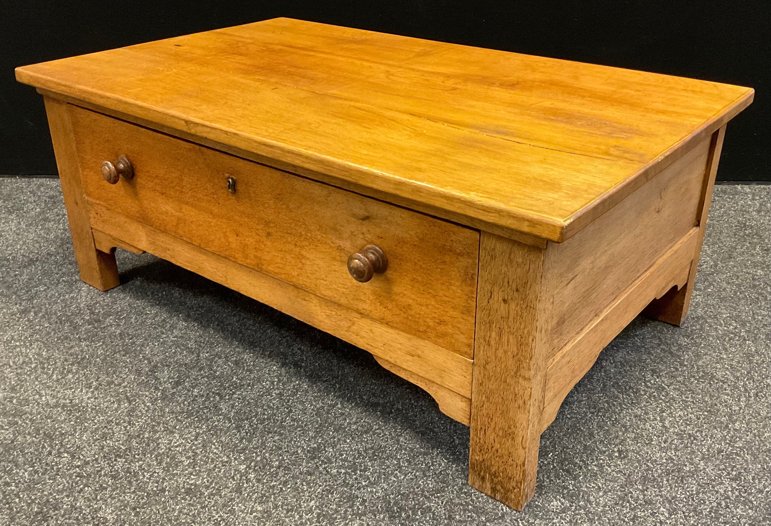 A contemporary oak coffee table, single large drawer to base, 43cm tall x 106cm x 65cm.