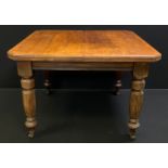 A Victorian mahogany extending dining table, rectangular top with canted corners, turned and