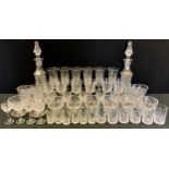 A pair of Tulia crystal waisted cut glass decanters, 38.5cm high; six champagne flutes, ten sundae