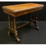 A Victorian walnut and burr walnut card table, rounded rectangular top, turned supports, ceramic