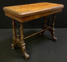 A Victorian walnut and burr walnut card table, rounded rectangular top, turned supports, ceramic