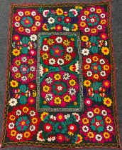 An Uzbek Suzani textile wall-hanging / throw, the bright and colourful Suzan needle-work depicting