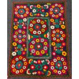 An Uzbek Suzani textile wall-hanging / throw, the bright and colourful Suzan needle-work depicting