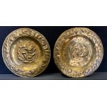 A pair of 19th century Arts & Crafts hammered brass dishes, embossed leaf and floral decoration,