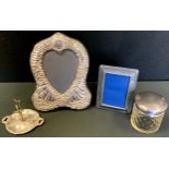A silver mounted velvet heart photograph frame, Birmingham 1997; Edwardian silver ring tree,