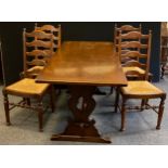 A mid century oak dining suite, comprising a set of four ladder-back chairs, with drop-in rush