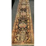 An antique Qashqai type Persian runner carpet / rug, hand-knotted with stylised people, birds, and