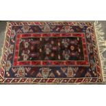 A Persian/Turkish hand knotted rug, central rectangular panel of geometric motifs, within four