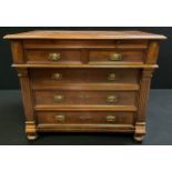 A late 19th century French walnut chest of drawers with brushing slide to over-sailing top, above