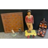 A mid 20th century carved oak and painted figure of a golfer, 67cm tall; a large wooden chess board;