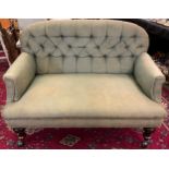 A late Victorian button back two seat sofa, turned mahogany legs, 118cm wide x 65cm deep.