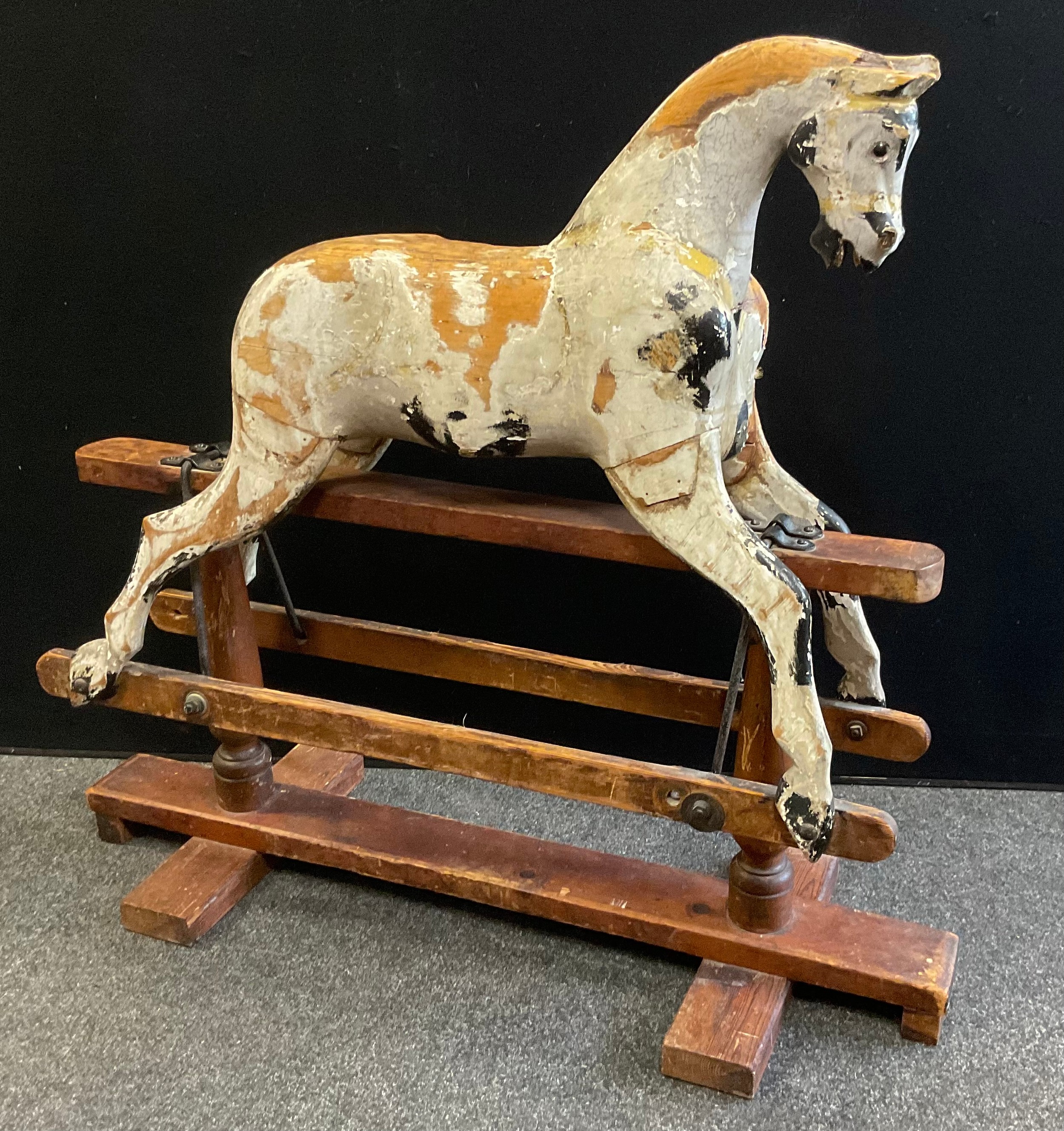 A late Victorian/Edwardian painted wooden rocking horse, for restoration, part stripped wooden