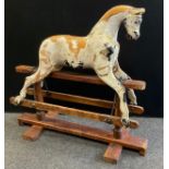 A late Victorian/Edwardian painted wooden rocking horse, for restoration, part stripped wooden
