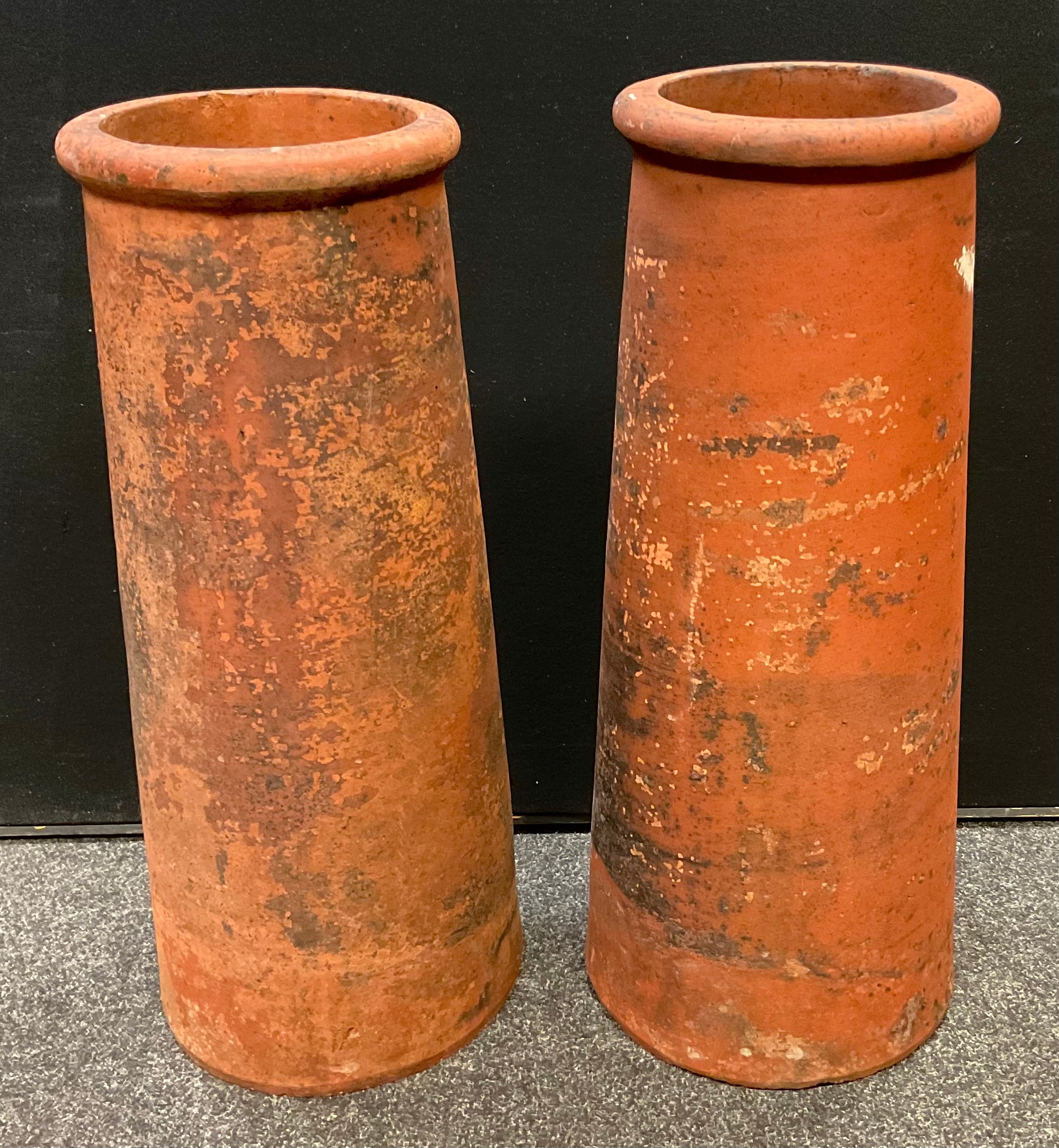 A pair of Victorian canon barrel chimney pots, each measuring 78cm tall, (2).