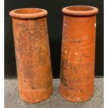 A pair of Victorian canon barrel chimney pots, each measuring 78cm tall, (2).