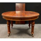A Victorian mahogany extending dining table, oval top, turned and reeded legs, ceramic casters,