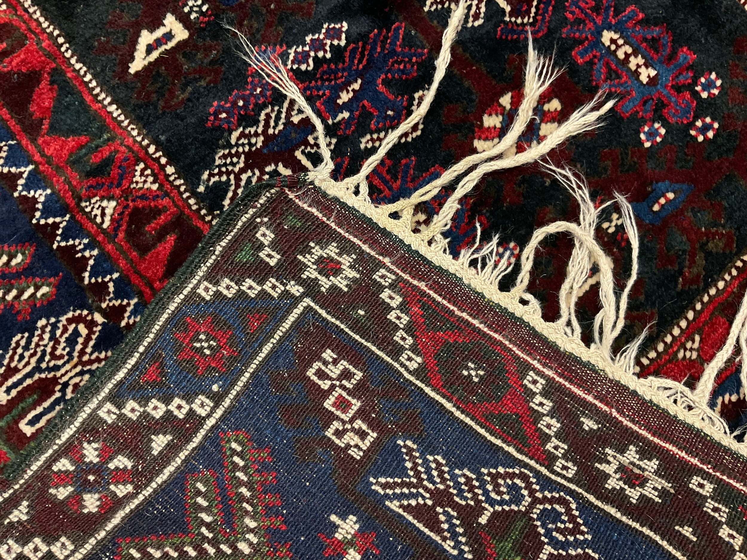 A Persian/Turkish hand knotted rug, central rectangular panel of geometric motifs, within four - Image 2 of 2