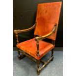 A William and Mary style high back walnut elbow chair studded leather back and seats, the arm carved