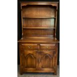 A Bevan Funnell oak dresser, plate-rack top, two drawers over pair of panelled doors to base,