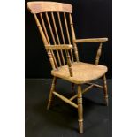 A 19th century Elm spindle back arm chair