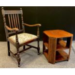 An early 20th century oak spindle back arm chair, drop in seat with William Morris type