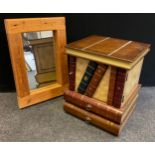 A novelty side table / cabinet as a stack of leather-bound books, having a small cupboard, above a