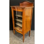 An Edwardian inlaid mahogany serpentine display cabinet, arched back, over sailing top, glazed