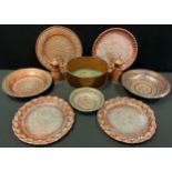 A pair of Persian copper chargers central floral panel, embossed rim, 28.5cm; others, bowls, pair of
