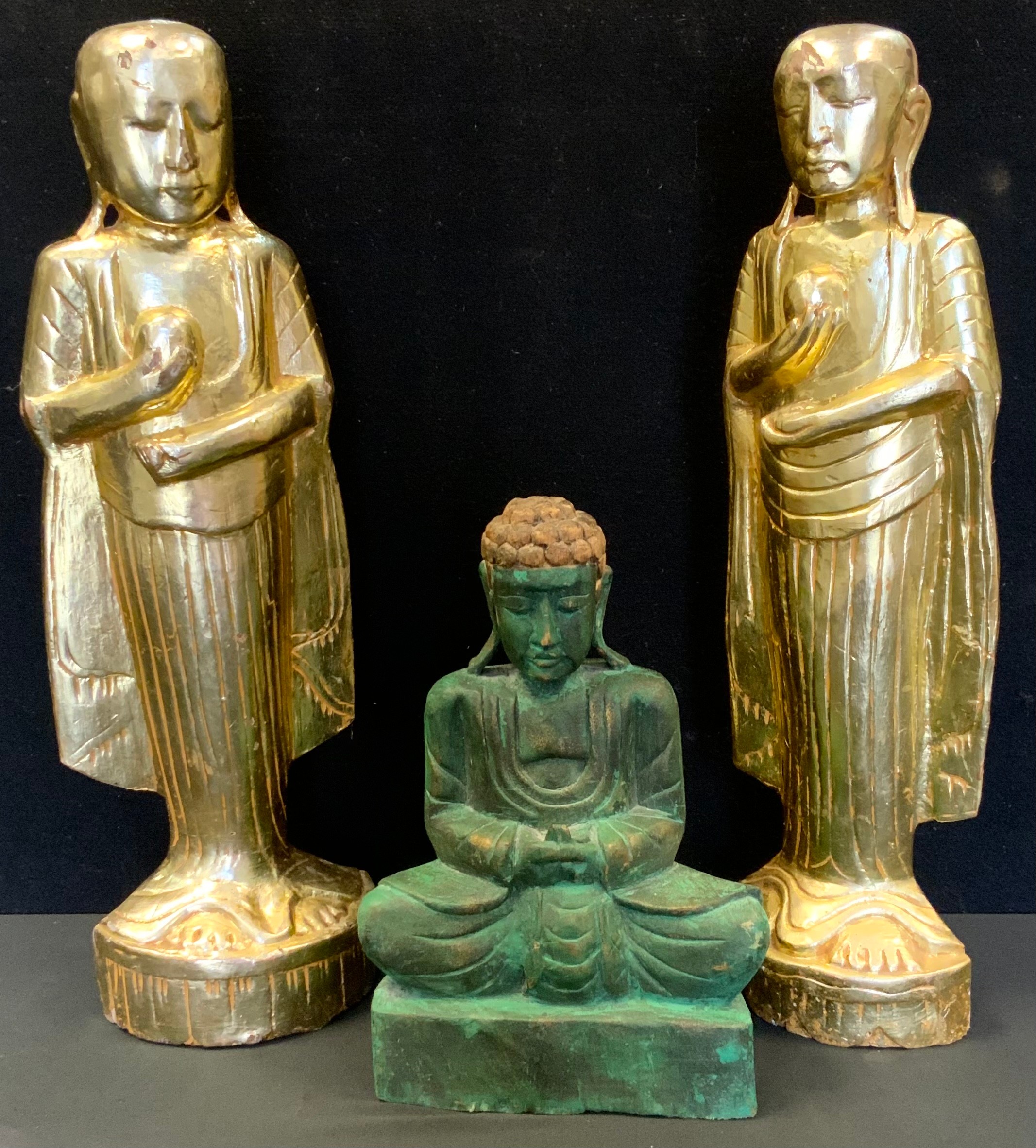 A pair of Buddhist carved and gilded figures, as Monks each holding a stupa, 50cm high; another