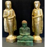 A pair of Buddhist carved and gilded figures, as Monks each holding a stupa, 50cm high; another