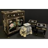 A contemporary oriental, ebonised, carved, and painted side cabinet, two short drawers above pair of