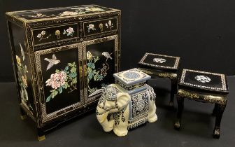 A contemporary oriental, ebonised, carved, and painted side cabinet, two short drawers above pair of
