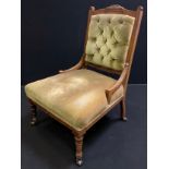 A Victorian mahogany nursing chair, carved cresting, button back, stuffed-over seat, turned legs,