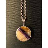 A blue john reversible disc pendant, silver mount and chain, 29mm diameter, C W Sellors, Sheffield