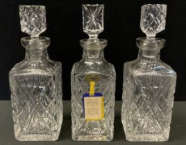 A pair of Tulia Polish lead crystal stoppered decanters, another different stopper, one with