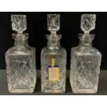 A pair of Tulia Polish lead crystal stoppered decanters, another different stopper, one with