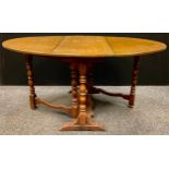 A Titchmarsh and Goodwin style oak gate-leg dining / kitchen table, oval top when leaves extended,