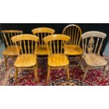 A set of three Beech wood spindle-back kitchen chairs; another, similar, mid 20th century splat back