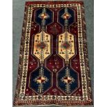 A South-west Persian Lori rug / carpet, hand-knotted in deep shades of burgandy, blue, and cream,