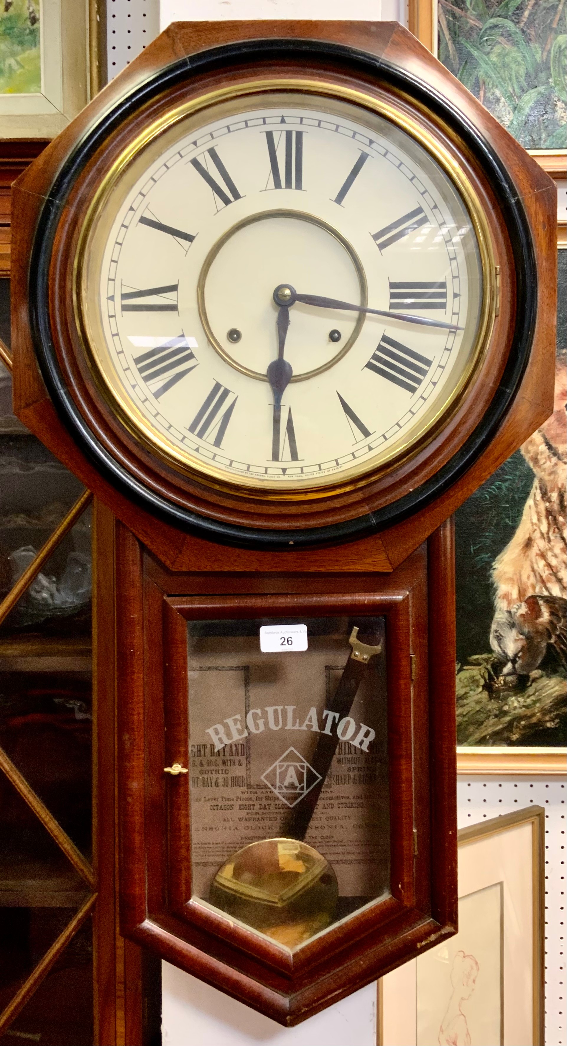 An American Ansonia Regulator wall clock, octagonal case, white dial, bold Roman numerals, 30 hour